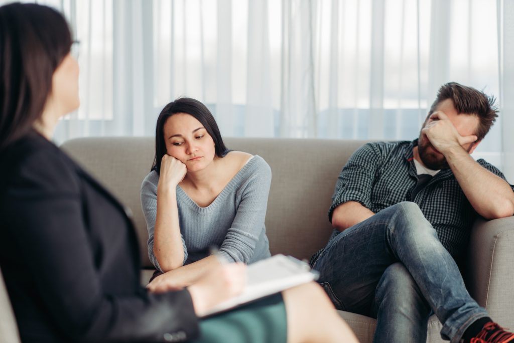Stressed couple patients at psychologist reception